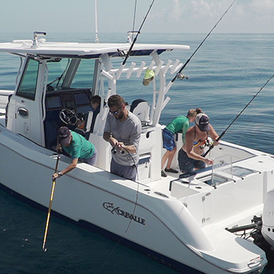 Image of a family fishing off of a Crevalle boat