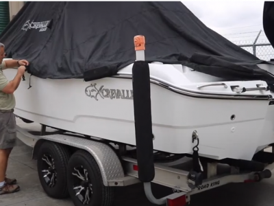 Man removing the cover of a Crevalle Boat